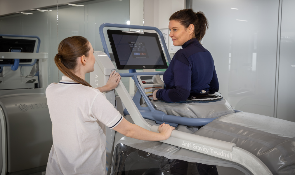 Woman on treadmill at LycaHealth orpington Physio facilities.